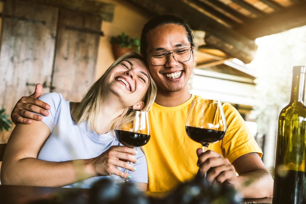 A couple enjoying glasses of red wine at the top wineries in Oregon near our Bed and Breakfast in McMinnville